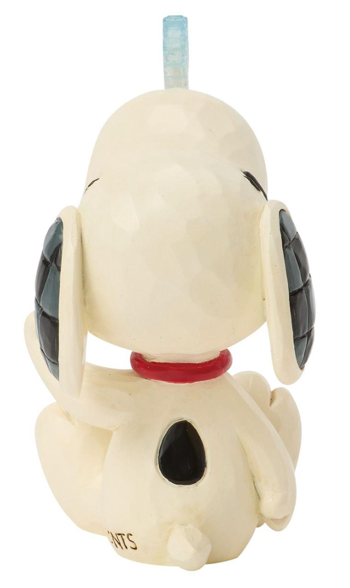A ceramic figurine of Snoopy sitting down, featuring a cream-colored body, black ears and spot, a red collar, and a light blue plastic straw on top.