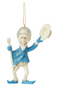 Decorative figurine of a person in blue attire with a hat and staff on a white background