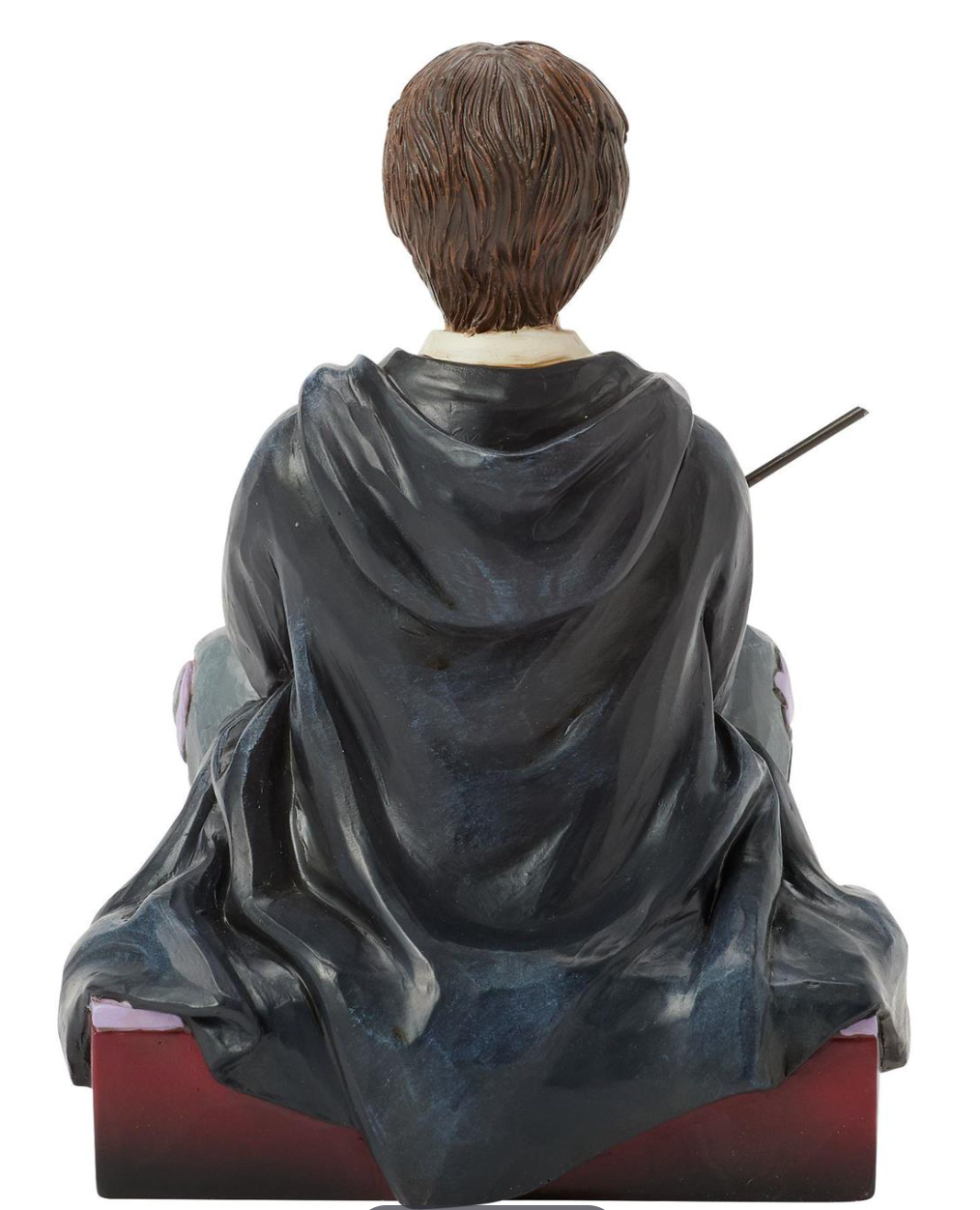 Figurine of a Harry Potter in a gray robe with a wand, sitting on a decorative base.Artist Jim Shore.