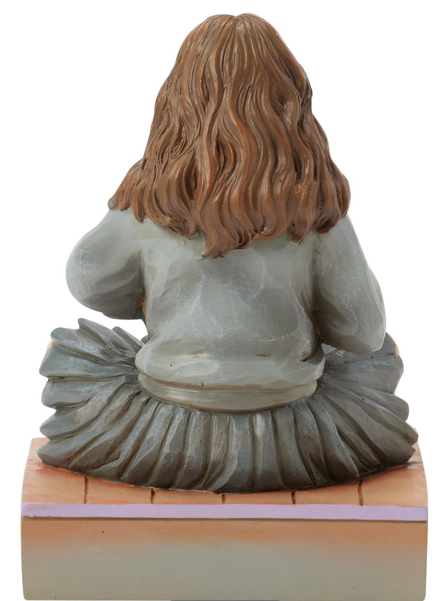Figurine of Hermione in a school uniform holding books on a decorative base with owls. Artist Jim Shore.