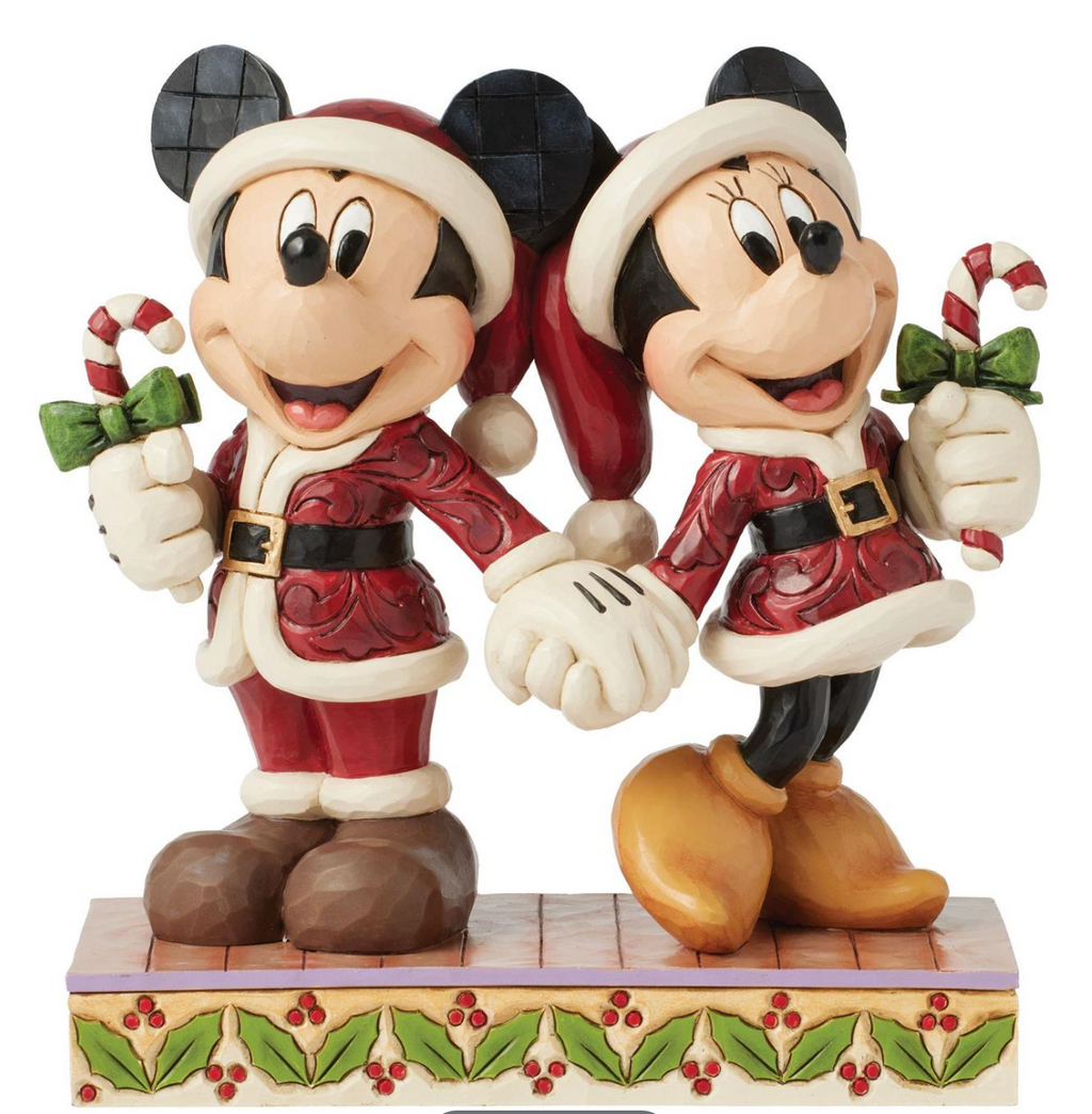 Disney's Mickey and MInnie Mouse figurines holding candy canes on a decorative base. Artist Jim Shore.