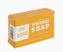 Load image into Gallery viewer, A rectangular box of Swag Brewery Kentucky Bourbon Whiskey Soap, featuring a mustard yellow-orange color with white text and a white side panel showing the brand logo and barcode.
