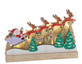 Decorative Christmas scene with Santa Claus, reindeer, and a house on a white background