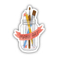 Sticker with a jar of art supplies and 'MAKE ART' banner on a white background