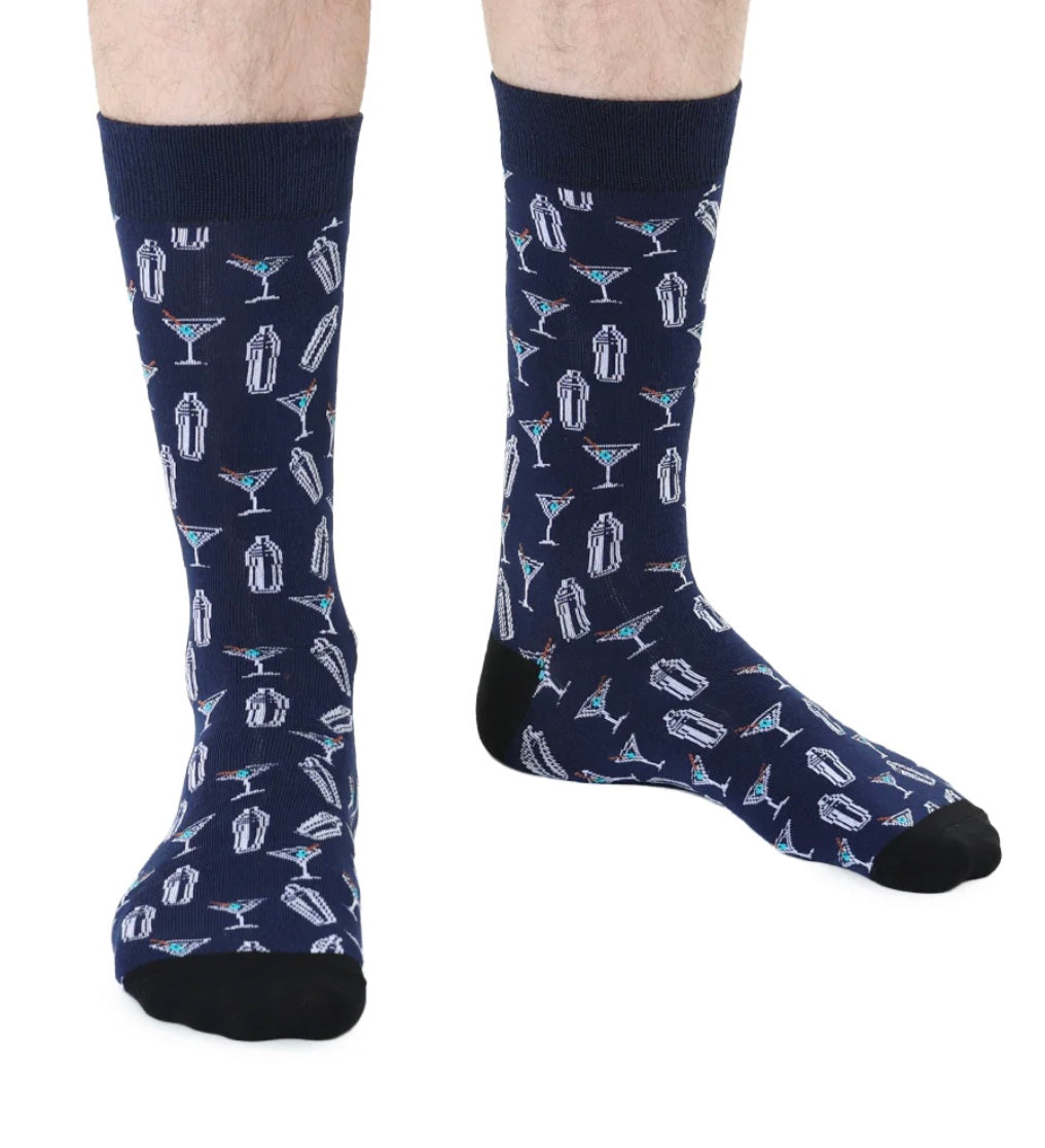 Navy socks with cocktail pattern worn by a person on a white background