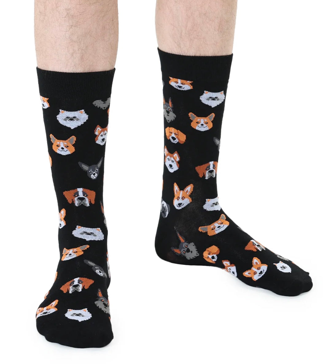 Black socks with dog pattern worn by a person on a white background