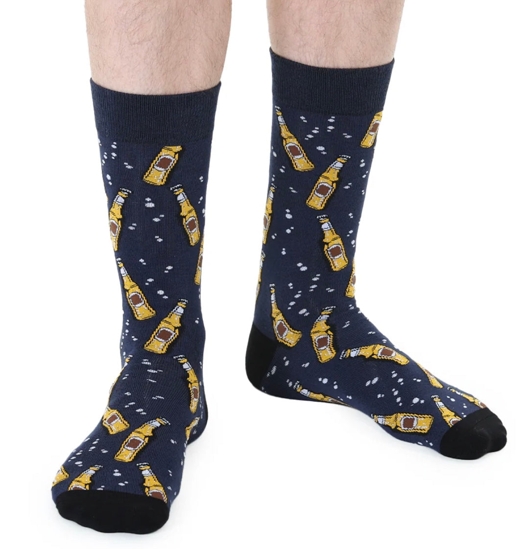 Navy socks with beer bottle pattern worn by a person on a white background