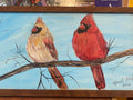 Painting of two cardinals on a branch with a blue sky background.
