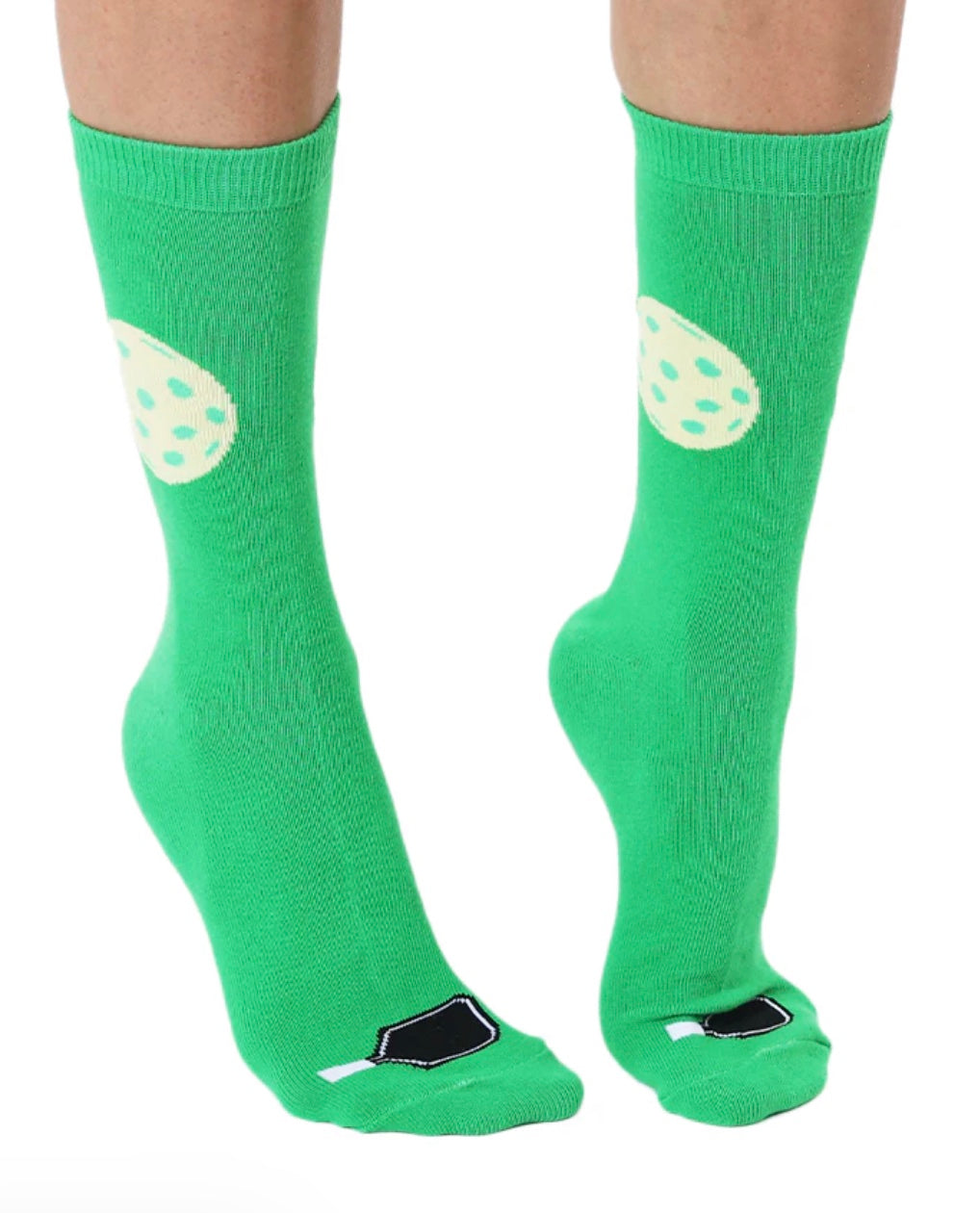 Green socks with white paw prints worn by a person on a white background