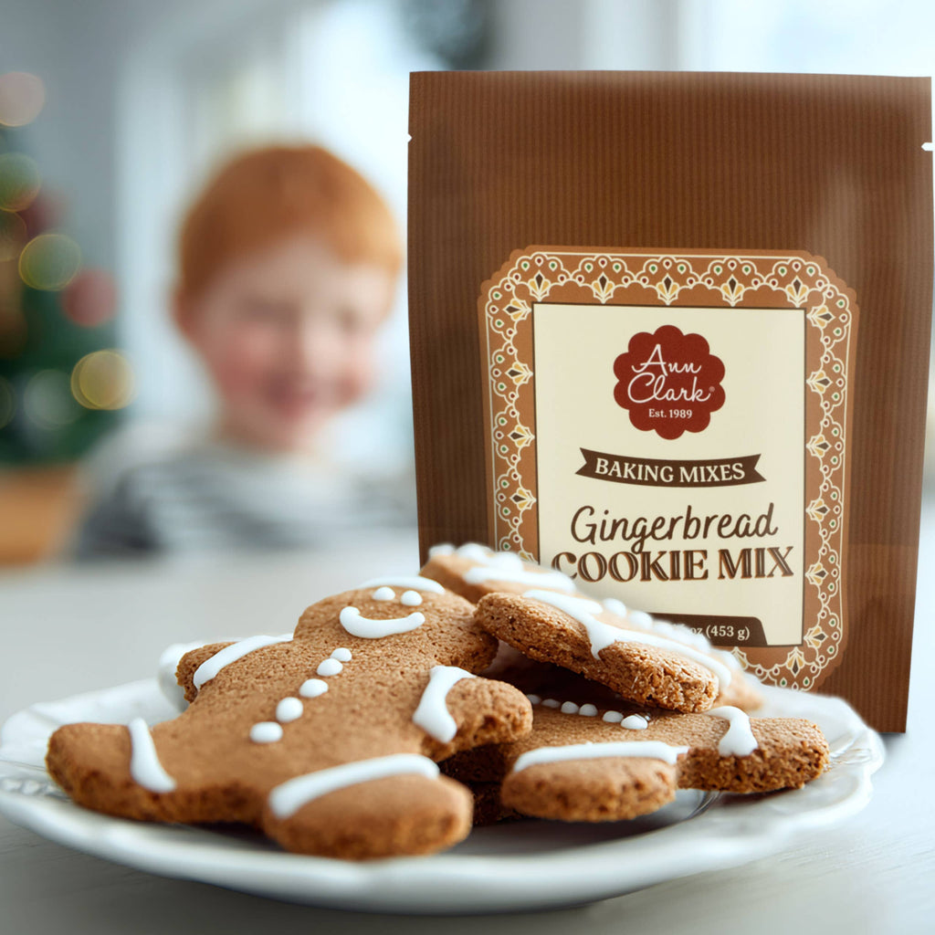 Gingerbread cookies on a plate with a box of Ann Clark Gingerbread Cookie Mix in the background.