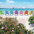 Colorful Adirondack chairs on a sandy beach with flowers and sailing boats in the background.