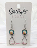 Earrings with rainbow cloud design on a 'Starlight Story' branded card.
