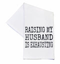 White towel with black text 'RAISING MY HUSBAND IS EXHAUSTING' on a white background