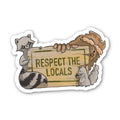 Sticker with raccoon holding a sign saying 'Respect the Locals' on a white background