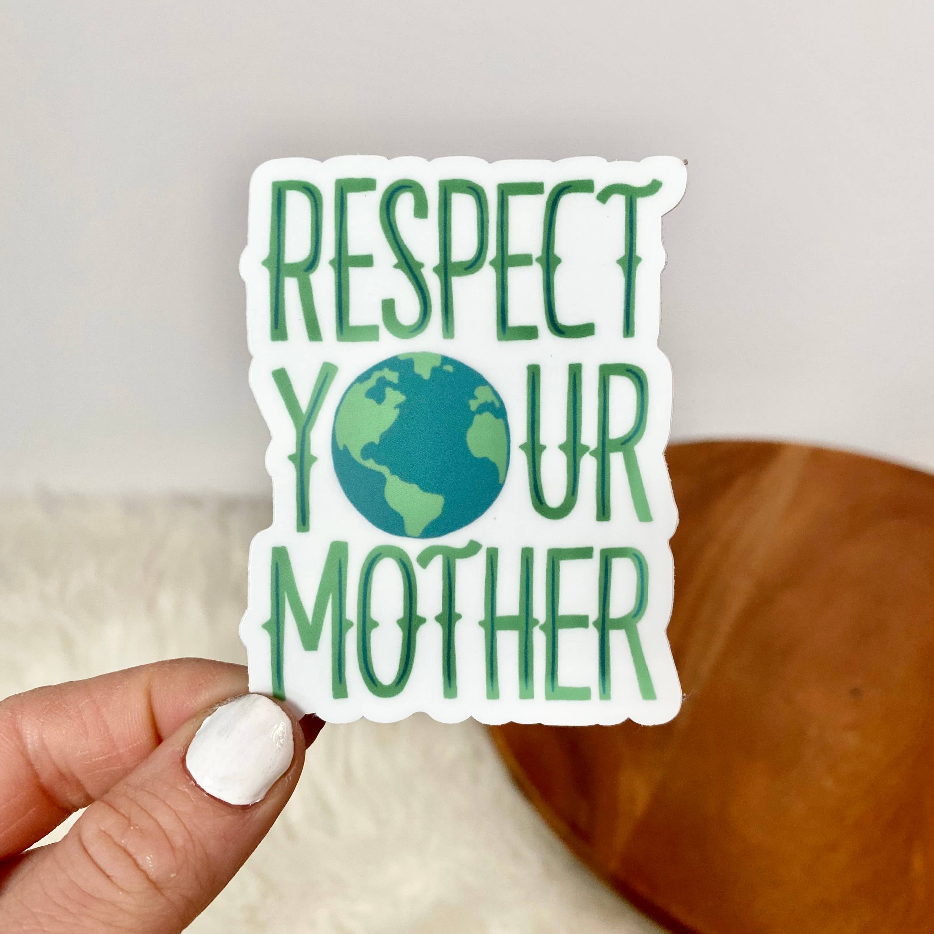 Sticker with 'Respect Your Mother' text held by a hand against a neutral background