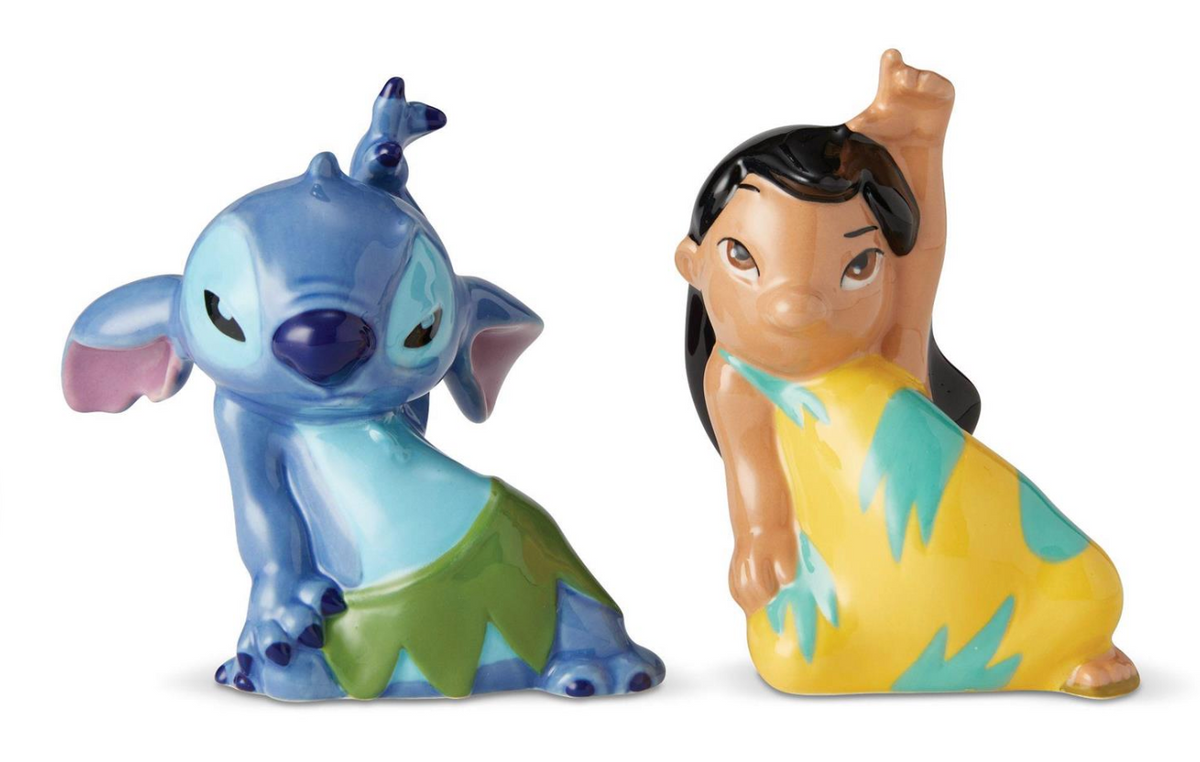 Two ceramic figurines of a blue character and a girl in a yellow dress on a white background