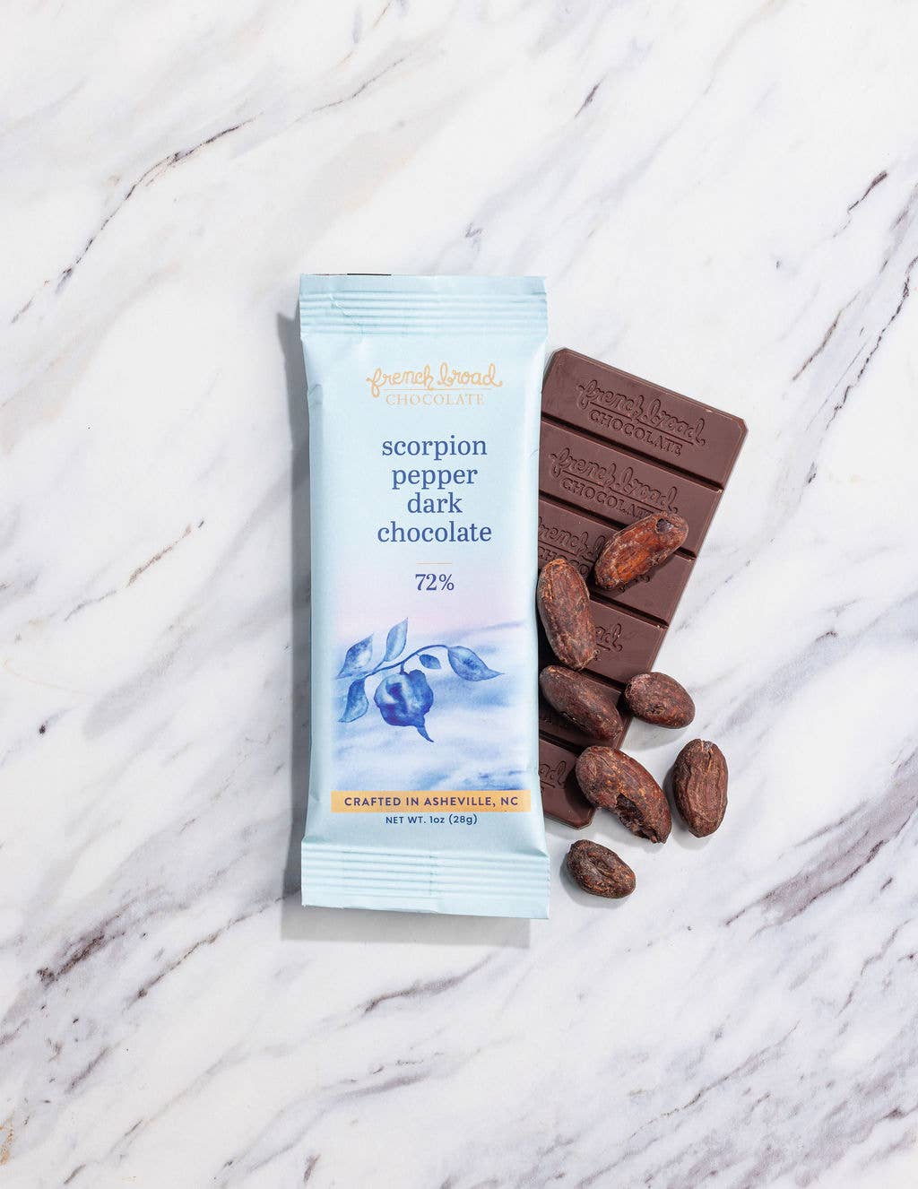 Scorpion pepper dark chocolate bar with packaging on a marble surface