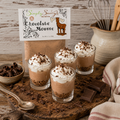 Chocolate mousse in small glasses with whipped cream on a wooden board, surrounded by chocolate pieces and a 'Simply Savory' label.