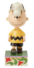 Load image into Gallery viewer, Figurine of a character with a yellow shirt and black pants on a decorative base.
