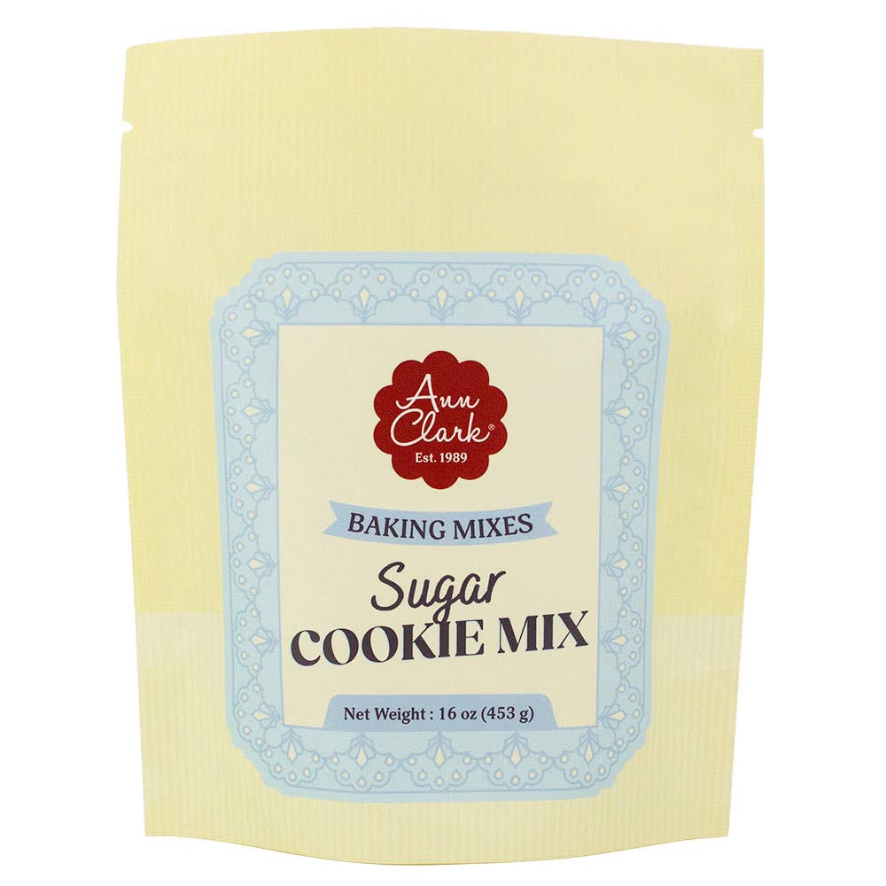 A 16 oz stand-up pouch of Ann Clark Baking Mixes Sugar Cookie Mix, featuring a pale yellow package with a central cream label and a light blue decorative border.