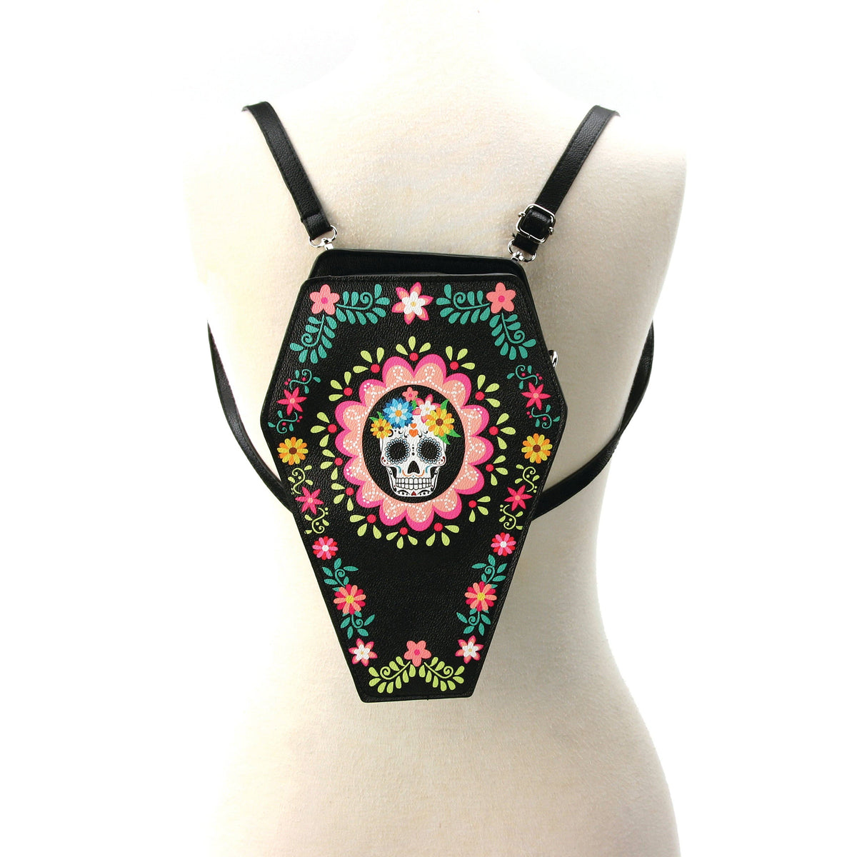 Black coffin-shaped bag with colorful floral and skull design on a mannequin.