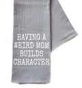 Gray towel with white text 'HAVING A WEIRD MOM BUILDS CHARACTER' on a white background