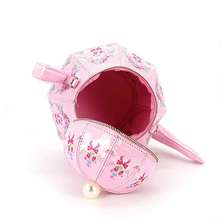 Pink pet carrier with floral design on a white background