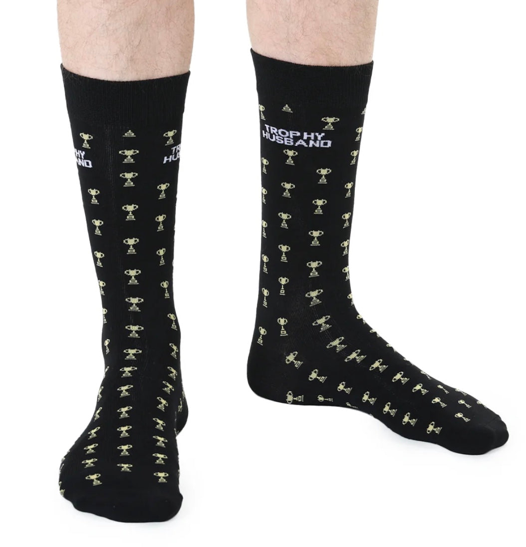 Black socks with white text and trophy patterns on a white background