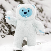 Load image into Gallery viewer, Plush toy resembling a snow creature with blue face and accents in a snowy setting
