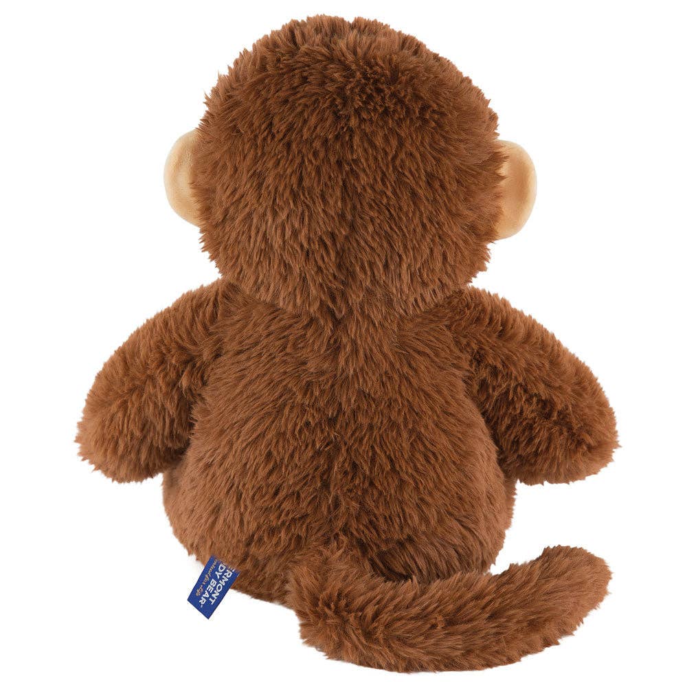 Brown plush monkey toy with a visible tag on a white background
