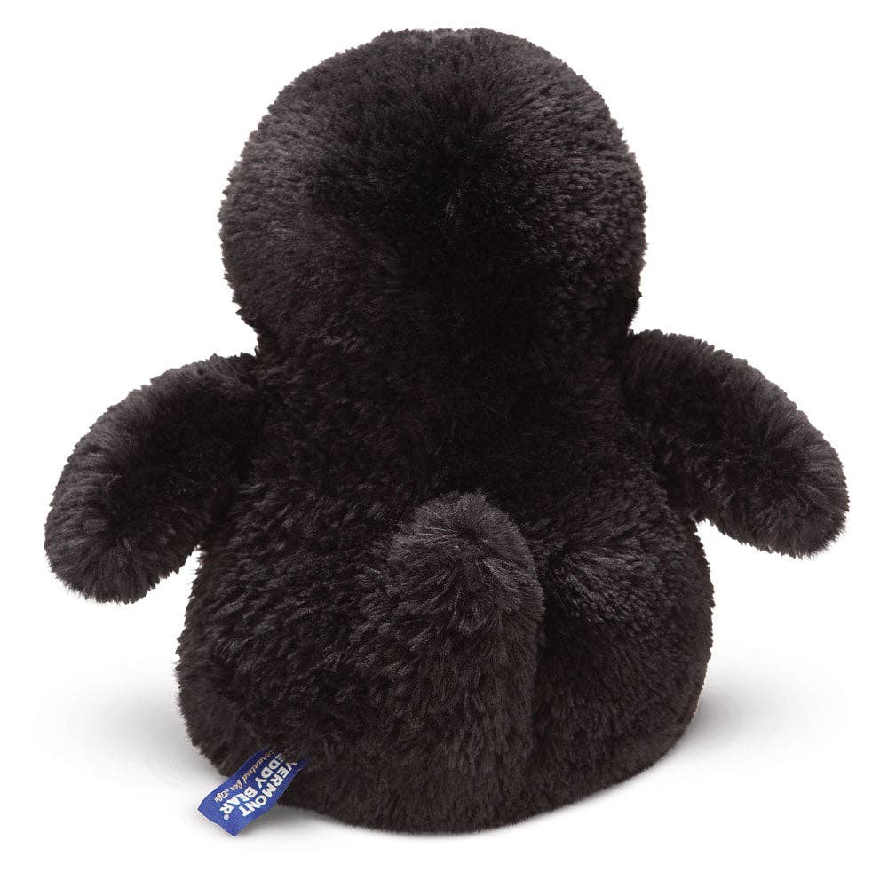 Black plush toy with a visible tag on a white background