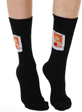 Load image into Gallery viewer, Black socks with cartoonish label design on a white background
