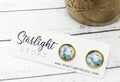 Pair of earrings with floral design on a Starlight Story branded card.